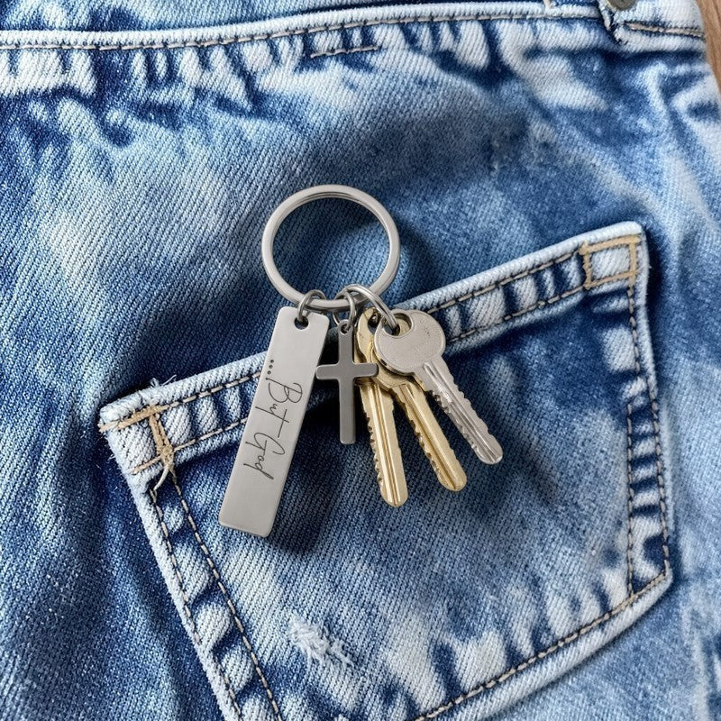 My Giving Store stainless steel keychain with a cross charm and engraved "...But God" pendant.