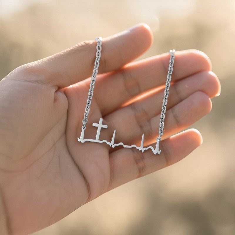 My Giving Store silver heartbeat cross necklace, a minimalist design symbolizing life and faith.