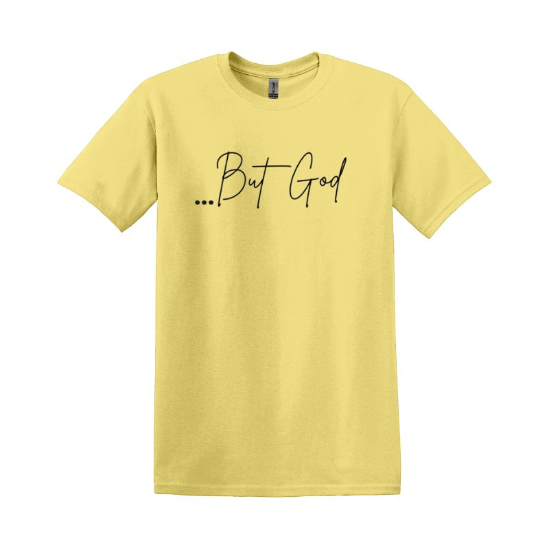 My Giving Store yellow 100% cotton t-shirt with black script text "...But God" on the front. Casual Christian apparel.